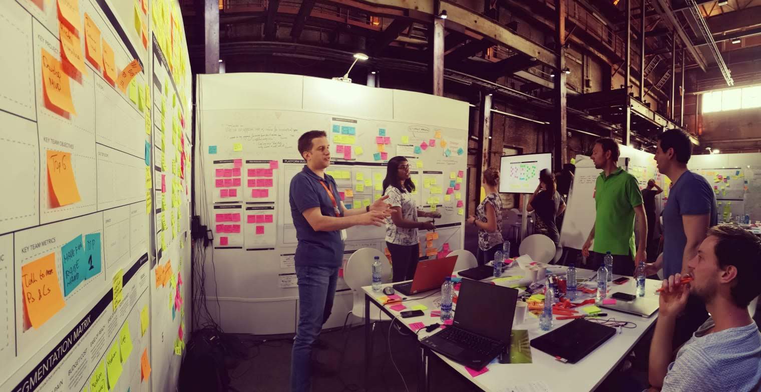 Sprint team working through business canvas and experiments in the bootcamp venue